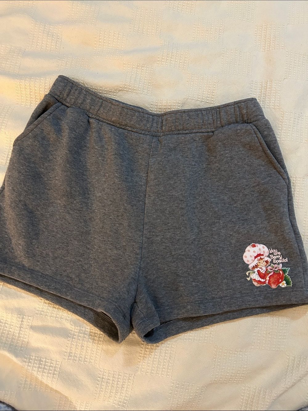 grey lounge shorts feature a "Strawberry Shortcake" graphic XL